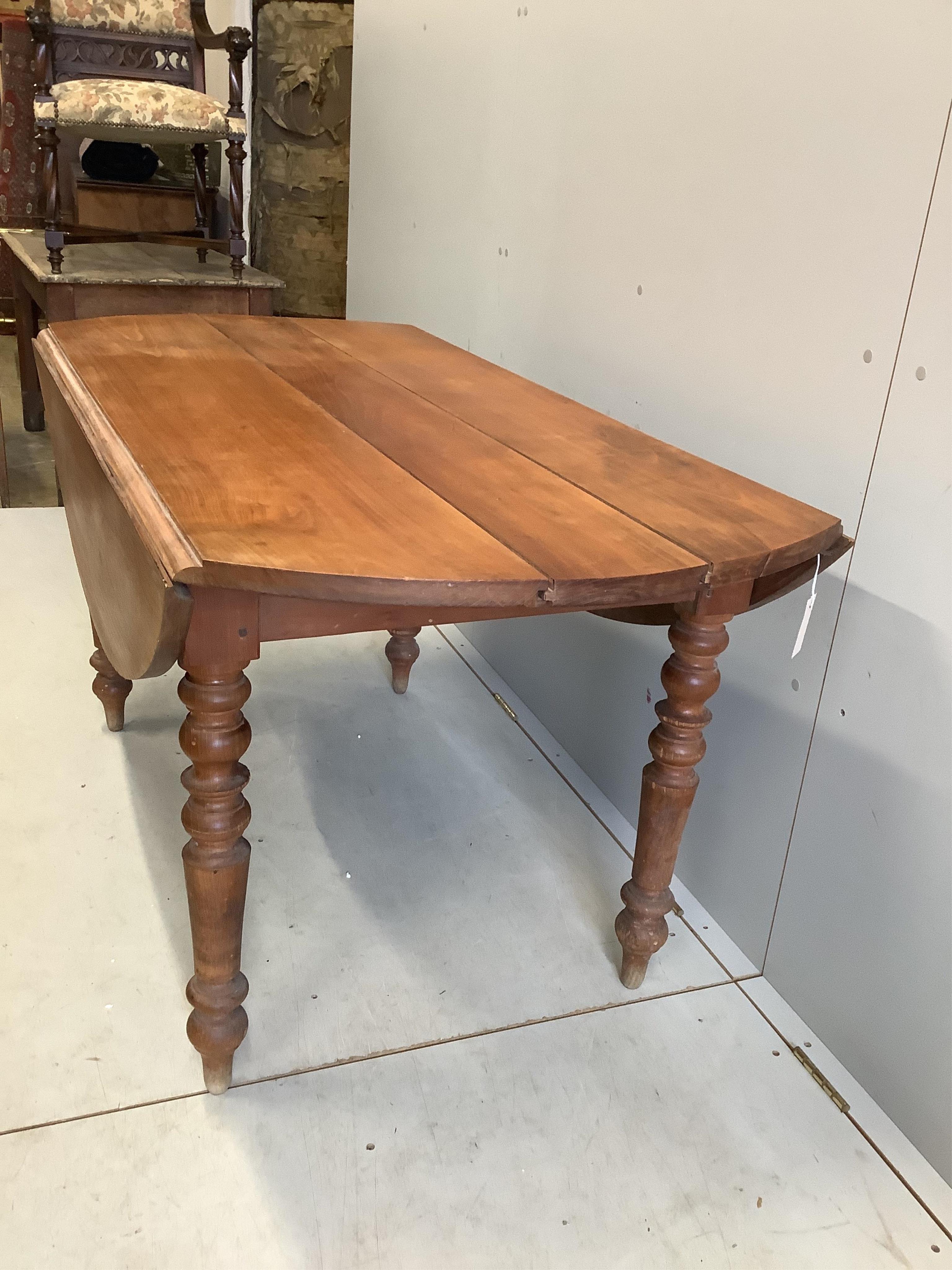 A 19th century French drop leaf cherry kitchen table, width 150cm, depth 75cm, height 74cm. Condition - poor
